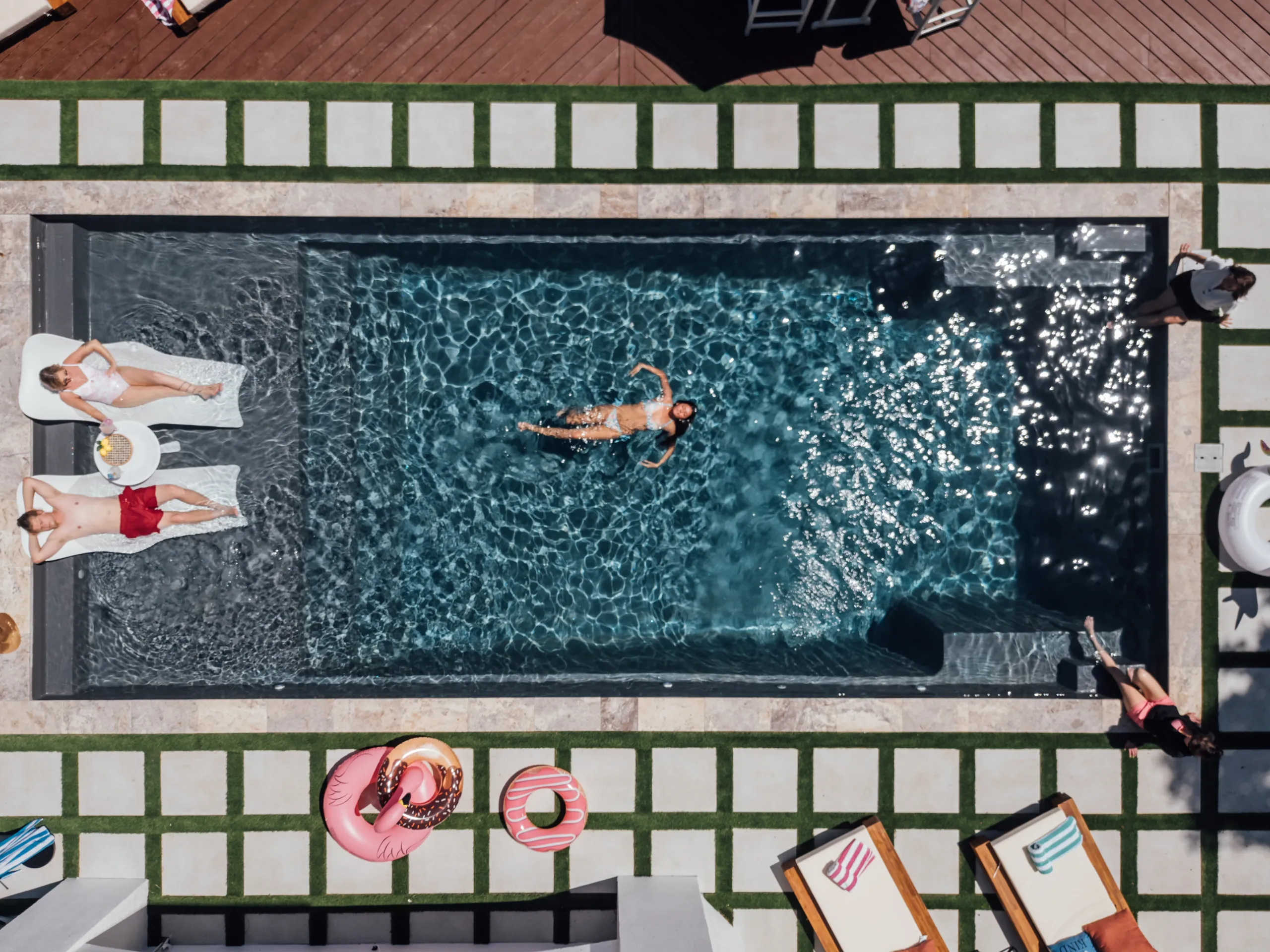 Overhead view of a luxury swimming pool representing the Headliner Stays vision